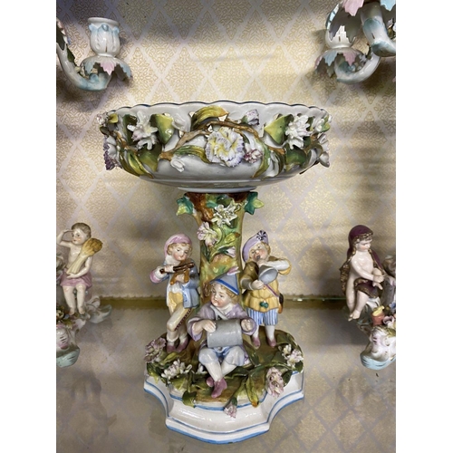 105 - AN ANTIQUE GERMAN SITZENDORF CENTREPIECE AND PAIR OF MEISSEN PORCELAIN CANDLEABRA, with five branche... 