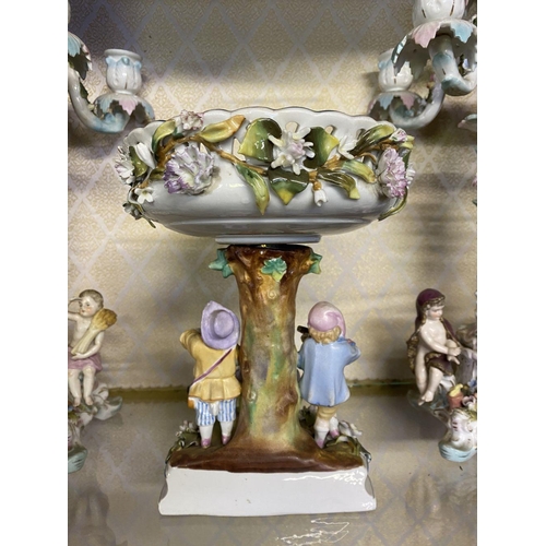 105 - AN ANTIQUE GERMAN SITZENDORF CENTREPIECE AND PAIR OF MEISSEN PORCELAIN CANDLEABRA, with five branche... 