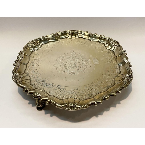 11 - AN ANTIQUE IRISH SILVER SALVER DISH, decorated with scrolling foliage and floral design surrounded m... 