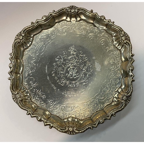 11 - AN ANTIQUE IRISH SILVER SALVER DISH, decorated with scrolling foliage and floral design surrounded m... 