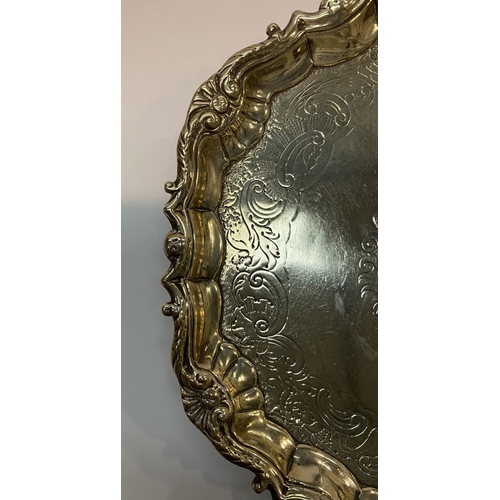 11 - AN ANTIQUE IRISH SILVER SALVER DISH, decorated with scrolling foliage and floral design surrounded m... 