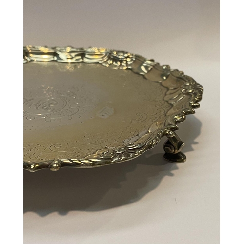 11 - AN ANTIQUE IRISH SILVER SALVER DISH, decorated with scrolling foliage and floral design surrounded m... 