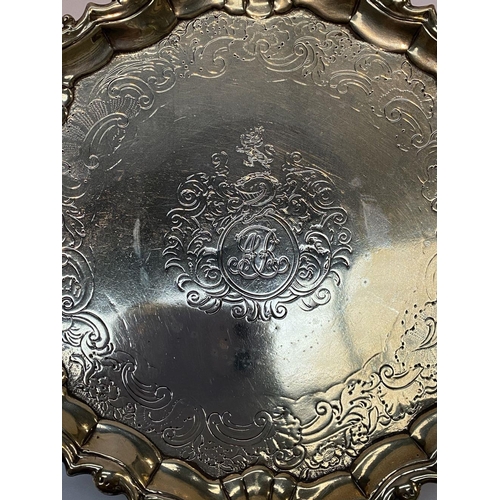 11 - AN ANTIQUE IRISH SILVER SALVER DISH, decorated with scrolling foliage and floral design surrounded m... 