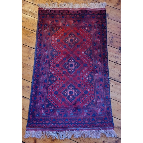 116 - A SMALL BOKHARA TRIBAL FLOOR RUG, with triple floral medallion design to the centre, multiple border... 