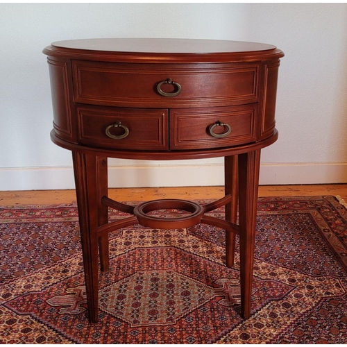 123 - A SMALL OVAL SHAPED THREE DRAWER TABLE / LAMP TABLE, contemporary piece in very good condition, some... 