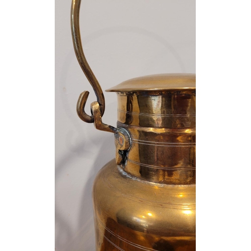 129 - A GOOD QUALITY MINIATURE BRASS CHURN with lid and swing handle, 23cm tall x 20cm wide - with the han... 