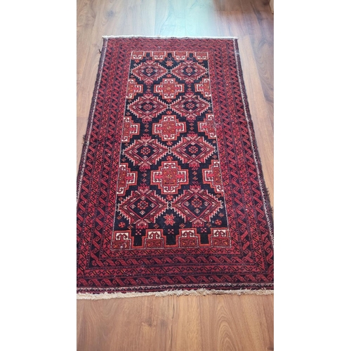 130 - A GOOD QUALITY VINTAGE BALUCH FLOOR RUG, main ground red, with central set of 8 medallions surrounde... 