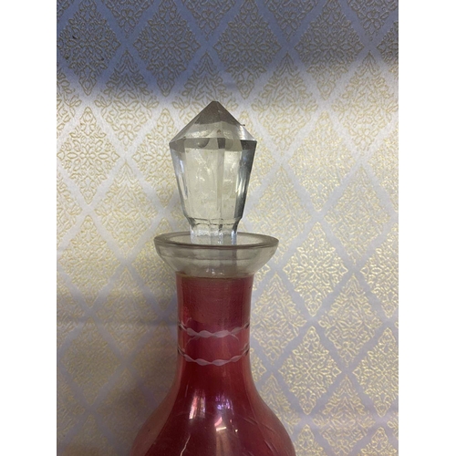 131 - A VINTAGE CRANBERRY ETCHED GLASS DECANTER ALONG WITH SIX CLEAR FOOTED GLASSES, grape floral design e... 