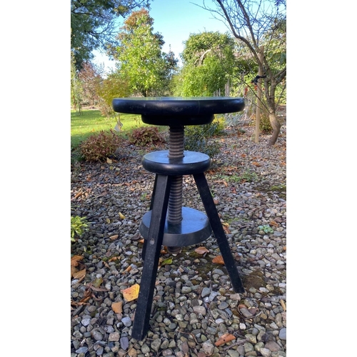 132 - A VINTAGE REVOLVING ‘CORKSCREW’ STOOL, in black with splayed tripod legs. Dimensions: 54cm high x 36... 