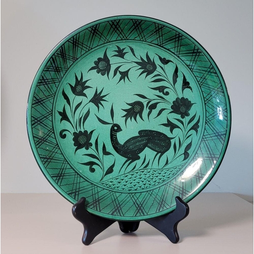 137 - A CONTEMPRARY HANDPAINTED & GLAZED DISPLAY PLATE, with silhouette design of a rabbit & foliage, sign... 