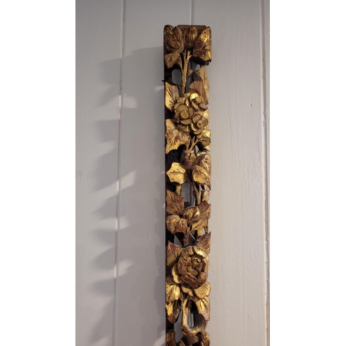 140 - AN ANTIQUE CARVED WALL PLAQUE - decorated with detailed floral design, gilt painted petals and leave... 