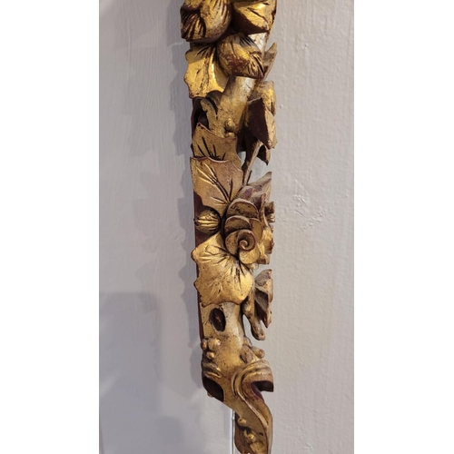 140 - AN ANTIQUE CARVED WALL PLAQUE - decorated with detailed floral design, gilt painted petals and leave... 