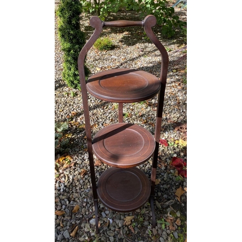 150 - A MAHOGANY INLAID THREE TIER CAKE STAND, inlay to three tiers, foldable, with handle. Dimensions: 88... 