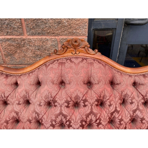 152 - A VINTAGE ROCOCO STYLE SETTEE, with curved shape, stained frame, finely upholstered with button back... 