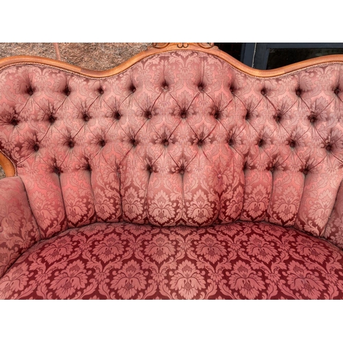 152 - A VINTAGE ROCOCO STYLE SETTEE, with curved shape, stained frame, finely upholstered with button back... 