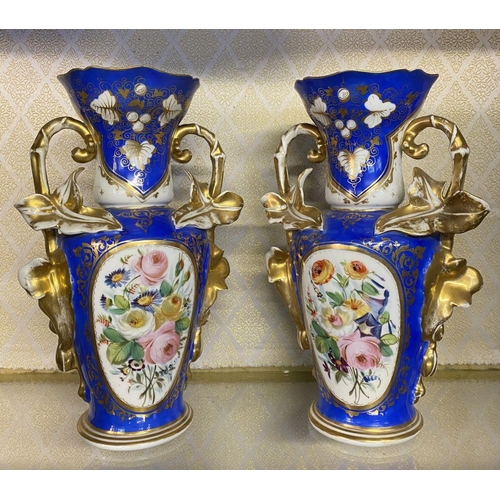 155 - A PAIR OF ORNATE PORCELAIN VASES, decorated with hand painted floral panels on blue ground with rich... 