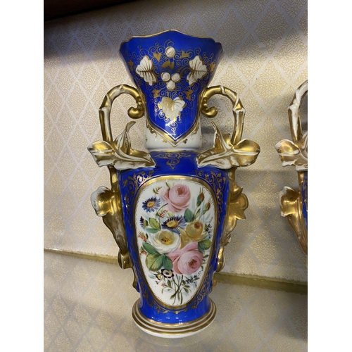 155 - A PAIR OF ORNATE PORCELAIN VASES, decorated with hand painted floral panels on blue ground with rich... 