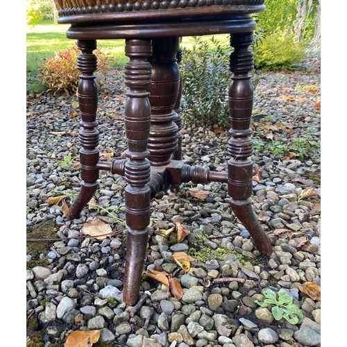 156 - A 19TH CENTURY MAHOGANY PIANO STOOL, with upholstered seat, standing on turned legs, with stretchers... 