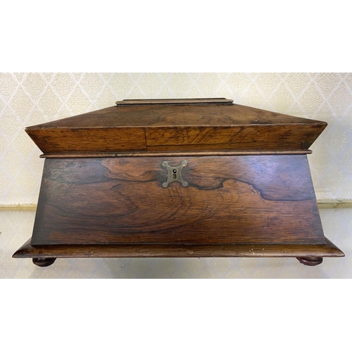 158 - AN ANTIQUE ROSEWOOD TEA CADDY, sarcophagus form, with scroll handles, standing on flattened bun feet... 