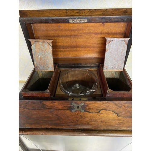 158 - AN ANTIQUE ROSEWOOD TEA CADDY, sarcophagus form, with scroll handles, standing on flattened bun feet... 