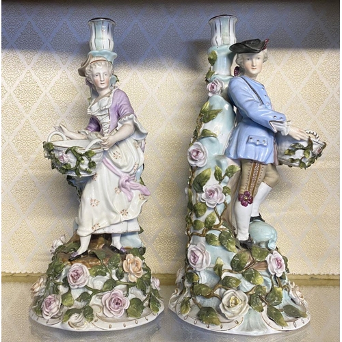 159 - A PAIR OF SITZENDORF CANDLEABRA, modelled with lady and gentleman in traditional dress carrying bask... 