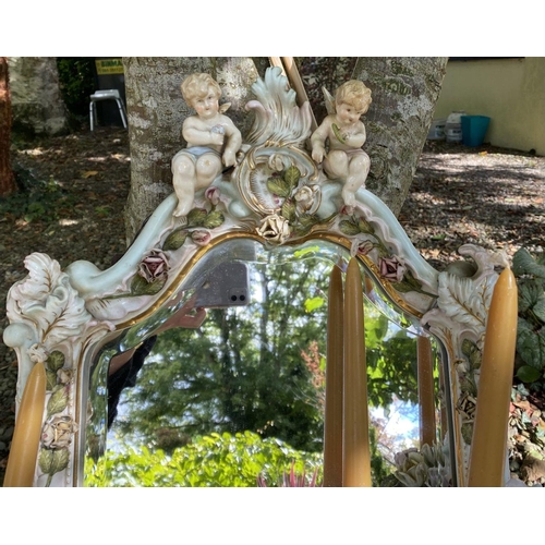 16 - A PAIR OF EXCELLENT 19TH CENTURY PORCELAIN CHERUB GIRANDOLE MIRRORS, of cartouche form, with bevelle... 