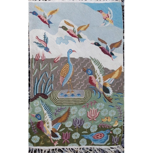 165 - A COLOURFUL TAPESTRY WALL HANGING, ‘DUCKS IN FLIGHT’, depicting birds in lakeside scene with waterli... 