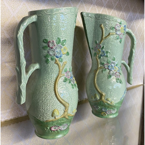 174 - A PAIR OF VINTAGE CROWN DEVON PAINTED JUGS, hand painted green with relief floral design, branch des... 