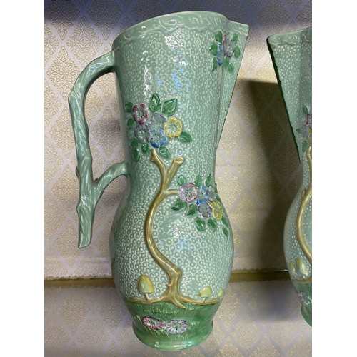 174 - A PAIR OF VINTAGE CROWN DEVON PAINTED JUGS, hand painted green with relief floral design, branch des... 