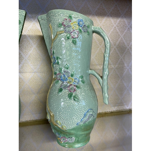 174 - A PAIR OF VINTAGE CROWN DEVON PAINTED JUGS, hand painted green with relief floral design, branch des... 