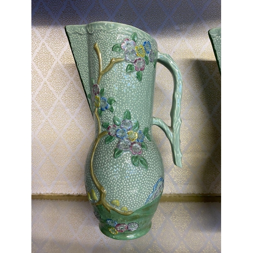 174 - A PAIR OF VINTAGE CROWN DEVON PAINTED JUGS, hand painted green with relief floral design, branch des... 