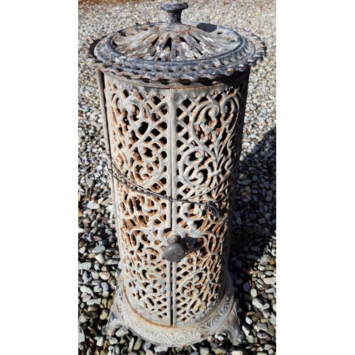 175 - A VICTORIAN CAST IRON STOVE, with decorative scrolling pierced design surrounding, finial to top, on... 