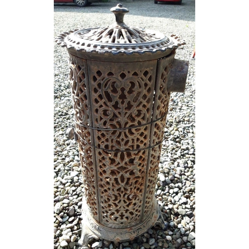 175 - A VICTORIAN CAST IRON STOVE, with decorative scrolling pierced design surrounding, finial to top, on... 