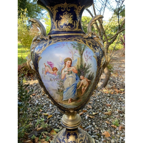 18 - A PAIR OF LARGE FRENCH SERVES PORCELAIN COVERED VASES, with ornate decoration including painted pane... 