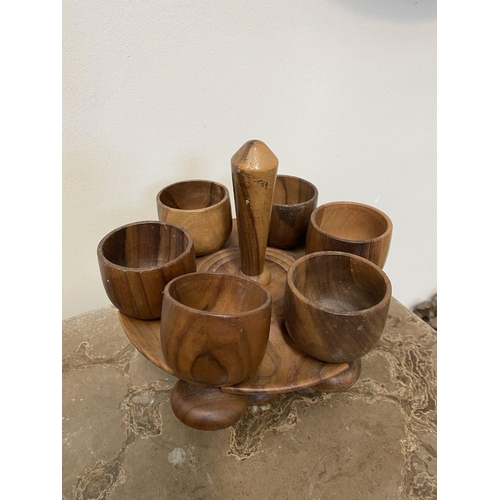 191 - A SET OF SIX WOODEN GOBLETS WITH HOLDER, 18cm high approx, along with four harlequin shot glasses wi... 