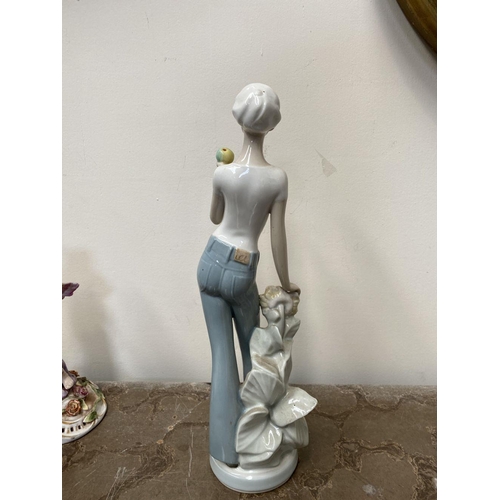 194 - A ROYAL DUX CERAMIC FIGURINE, ‘Woman in Winter’ c.1960, marked to base, along with a pair of vintage... 