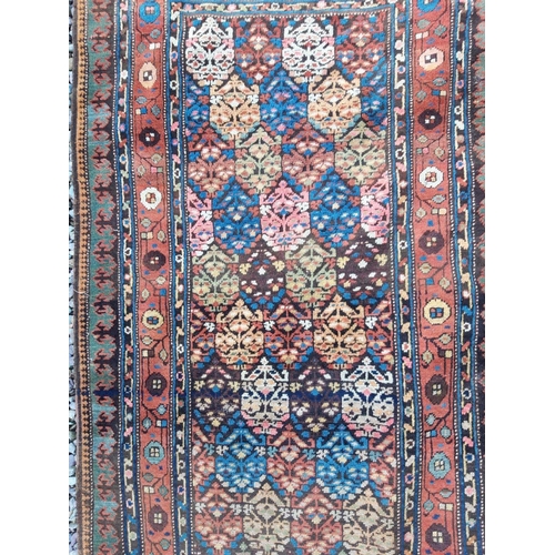 211 - A VERY FINE CAUCASUS RUNNER RUG, c.1900. With repeat motif to centre surrounded by floral inner bord... 