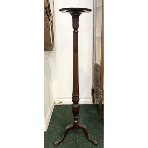 212 - A CARVED MAHOGANY PEDESTAL STAND, with circular top, turned and elaborately carved support atop trip... 