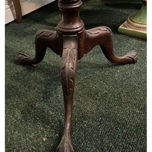 212 - A CARVED MAHOGANY PEDESTAL STAND, with circular top, turned and elaborately carved support atop trip... 