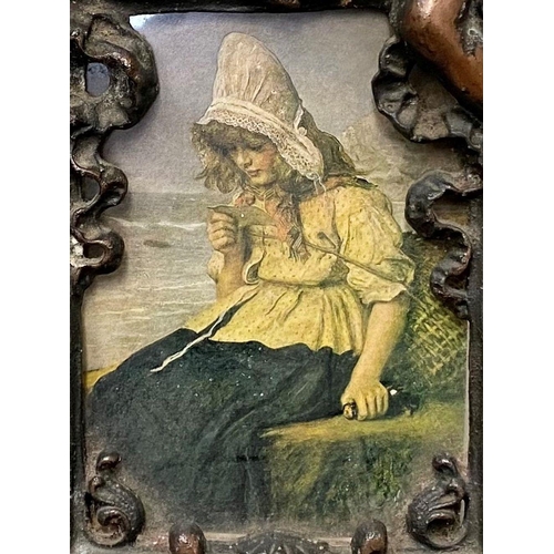 22 - A VICTORIAN CAST METAL PICTURE FRAME, featuring ornate design with two figures to top with floral cr... 