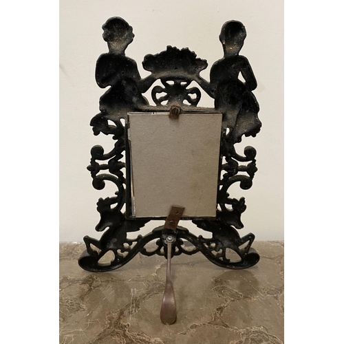 22 - A VICTORIAN CAST METAL PICTURE FRAME, featuring ornate design with two figures to top with floral cr... 