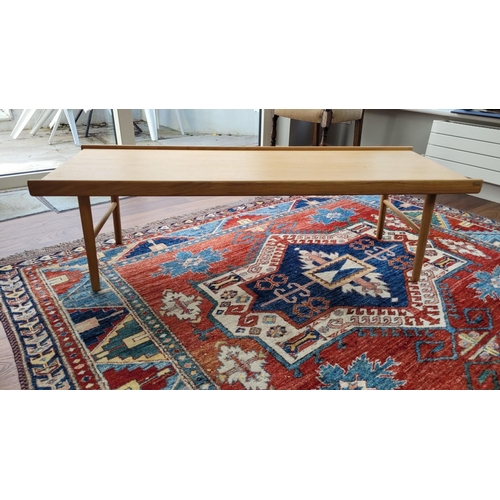 222 - A MID-CENTURY STYLE COFFEE TABLE, by Hübsch, with raised edges to the long sides, raised on tapered ... 