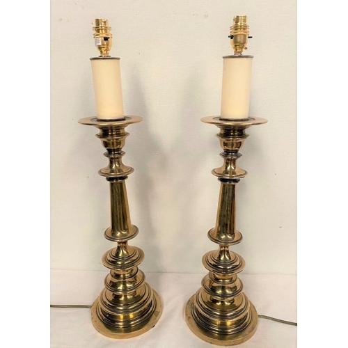 232 - A PAIR OF VICTORIAN POLISHED BRASS TABLE LAMPS, with turned supports on circular platform base, in w... 