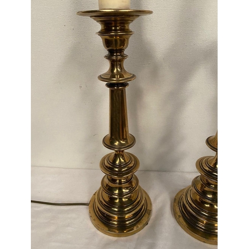 232 - A PAIR OF VICTORIAN POLISHED BRASS TABLE LAMPS, with turned supports on circular platform base, in w... 