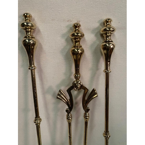 235 - A GOOD QUALITY SET OF THREE POLISHED BRASS FIRE IRONS, to include shovel, poker, tongs and dogs. All... 