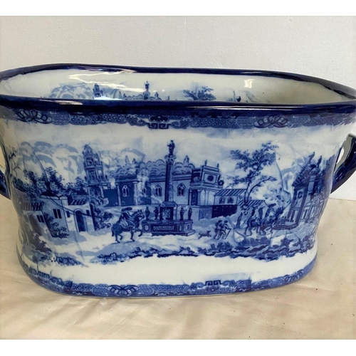 238 - AN OVAL BLUE AND WHITE FOOT BATH, with painted decoration to interior and exterior depicting country... 