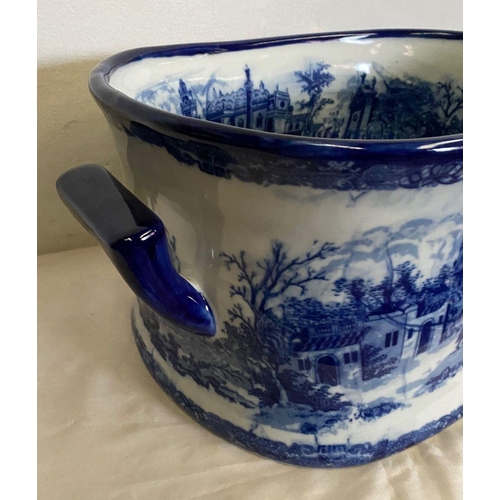 238 - AN OVAL BLUE AND WHITE FOOT BATH, with painted decoration to interior and exterior depicting country... 