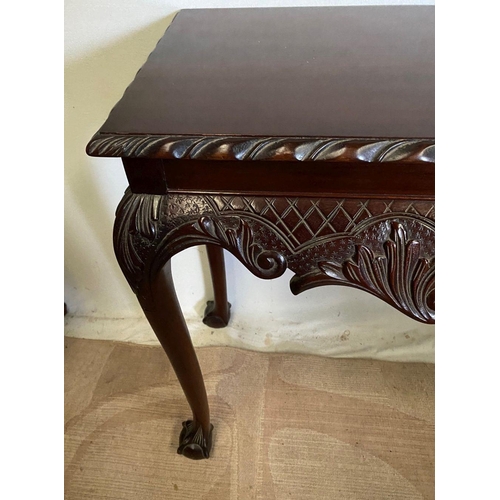 239 - AN IRISH STYLE MAHOGANY HALL TABLE, with gadrooned carving to edges above carved shaped frieze depic... 