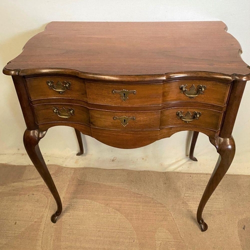 240 - A FINE MAHOGANY SHAPED LOW BOY, shaped top above two drawers with brass handles, on cabriole leg. Di... 