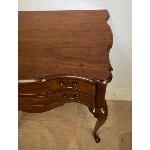 240 - A FINE MAHOGANY SHAPED LOW BOY, shaped top above two drawers with brass handles, on cabriole leg. Di... 